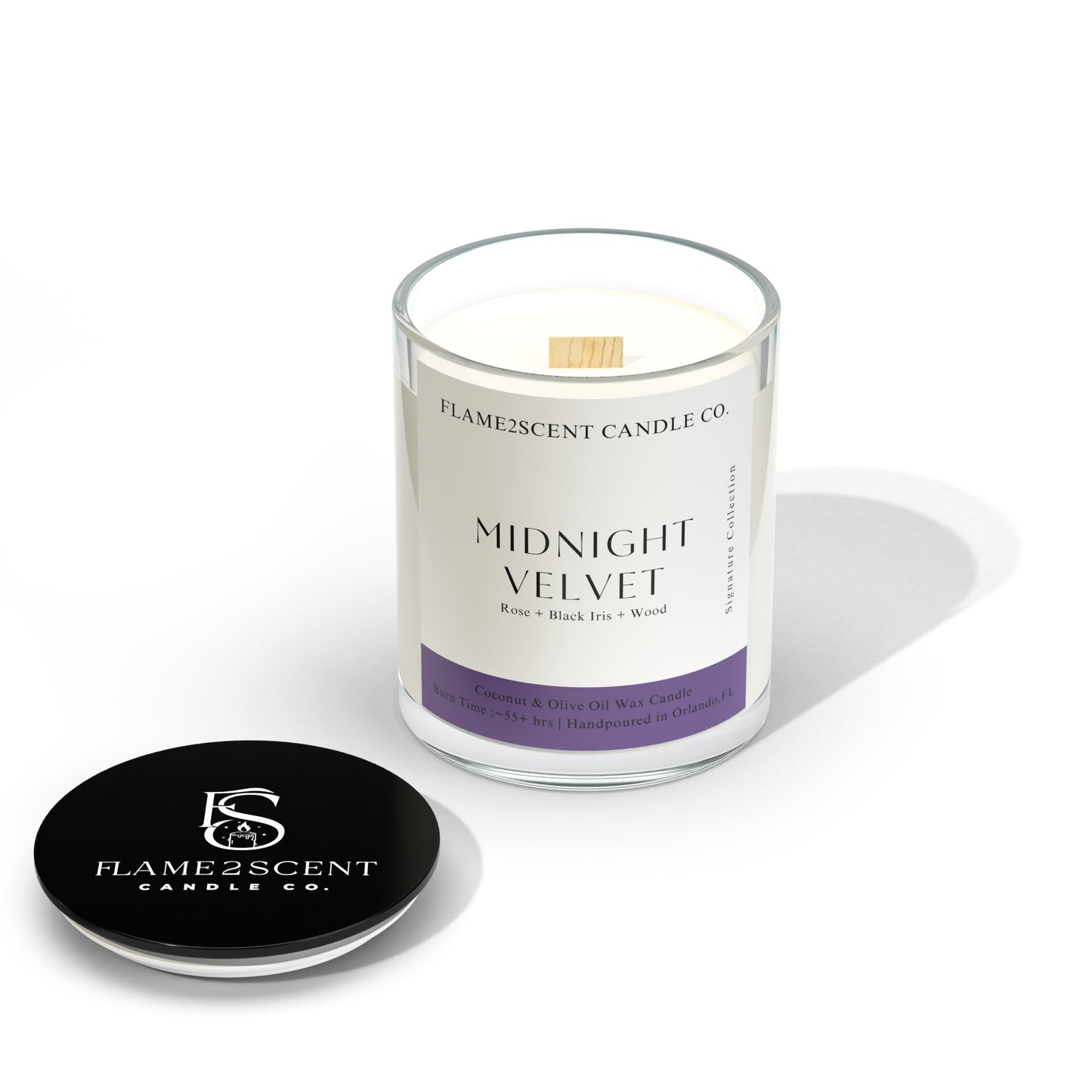 Midnight Velvet coconut wax candle with purple label, lit wood wick, and floral notes
