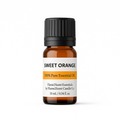 Sweet orange essential oil bottle with black cap on a white background